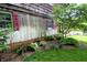Charming home exterior with red shutters, lush greenery, and well-maintained garden beds at 701 E Main St, Westfield, IN 46074