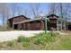 Exterior showcasing the home with brick and wood, a two car garage, and established front yard at 701 E Main St, Westfield, IN 46074