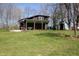 Rear view of home featuring a covered porch and well-maintained lawn at 701 E Main St, Westfield, IN 46074