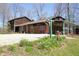 Exterior showcasing the home with brick and wood, a two car garage, and established front yard at 701 E Main St, Westfield, IN 46074