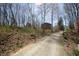 Exterior view of charming home with a long gravel driveway and early spring landscaping at 701 E Main St, Westfield, IN 46074