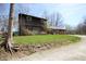 A rustic two-story home surrounded by lush greenery, showcasing its unique charm at 701 E Main St, Westfield, IN 46074