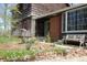 Charming home exterior with brick accents, a bench, and colorful flowering plants at 701 E Main St, Westfield, IN 46074