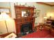 Elegant antique fireplace with decorative carvings and a cozy hearth, perfect for relaxation at 701 E Main St, Westfield, IN 46074