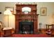 Antique fireplace with detailed carvings, offering a cozy focal point for the living space at 701 E Main St, Westfield, IN 46074