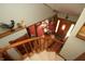 View from the staircase showing foyer with wood floors, red rug, and vintage lighting at 701 E Main St, Westfield, IN 46074