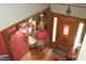 View from the staircase showing foyer with wood floors, red rug, and vintage lighting at 701 E Main St, Westfield, IN 46074