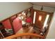 View from the staircase showing foyer with wood floors, red rug, and vintage lighting at 701 E Main St, Westfield, IN 46074
