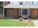 Charming home featuring a brick facade, bay window, and meticulously landscaped front yard at 701 E Main St, Westfield, IN 46074