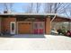 Garage and access doors with driveway and bonus covered storage on a sunny day at 701 E Main St, Westfield, IN 46074