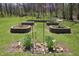 Charming garden with raised stone planters and blossoming flowers at 701 E Main St, Westfield, IN 46074
