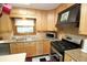 Bright eat-in kitchen with natural wood cabinets and stainless steel appliances at 701 E Main St, Westfield, IN 46074