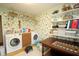 Well-equipped laundry room featuring washer, dryer, and shelving for storage solutions at 701 E Main St, Westfield, IN 46074