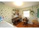 Functional laundry room with a wooden desk, ample storage, and floral patterned wallpaper at 701 E Main St, Westfield, IN 46074