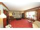 Spacious living room features hardwood trim, bay window, classic furniture, and ornate fireplace at 701 E Main St, Westfield, IN 46074