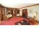 Living room with hardwood trim, ornate fireplace, vintage furniture, and decorative accents at 701 E Main St, Westfield, IN 46074