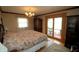 Well-lit main bedroom boasts a comfortable bed, and access to the outdoors at 701 E Main St, Westfield, IN 46074