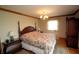Comfortable main bedroom featuring hardwood floors, and floral bedding at 701 E Main St, Westfield, IN 46074