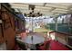 Covered outdoor dining with unique light fixture and quaint backyard view at 701 E Main St, Westfield, IN 46074
