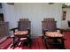 Cozy outdoor seating area with two wooden rocking chairs and striped cushions at 701 E Main St, Westfield, IN 46074