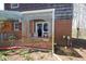 Enclosed brick porch with decorative lattice railing and garden area at 701 E Main St, Westfield, IN 46074