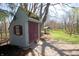 Charming storage shed situated in a lush backyard with an overhead covering at 701 E Main St, Westfield, IN 46074