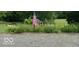 Landscaped yard featuring flower garden and an American flag at 701 E Main St, Westfield, IN 46074