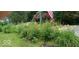 A yard and garden featuring colorful flowers and an American flag on display at 701 E Main St, Westfield, IN 46074