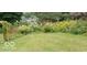 A charming yard with an archway, flowers, and lush green lawn at 701 E Main St, Westfield, IN 46074