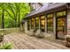 Back deck with seating offers tranquil views of the surrounding wooded area at 7249 Tuliptree Trl, Indianapolis, IN 46256