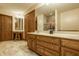 Large bathroom with double vanities, neutral-toned floor, a vanity area, and a separate shower area at 7249 Tuliptree Trl, Indianapolis, IN 46256