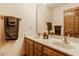 Bathroom with double sinks, mirror, and a wood framed vanity at 7249 Tuliptree Trl, Indianapolis, IN 46256