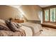 Bedroom with view of back yard, bed, window seat, carpet, and neutral colors at 7249 Tuliptree Trl, Indianapolis, IN 46256