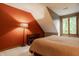 Bedroom with red accent wall and a window with a view of the backyard at 7249 Tuliptree Trl, Indianapolis, IN 46256