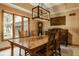 Elegant dining room with stylish table, chairs, chandelier, and natural light from windows at 7249 Tuliptree Trl, Indianapolis, IN 46256