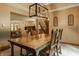 Dining area with hardwood table, chairs, and view into an adjacent living area and staircase at 7249 Tuliptree Trl, Indianapolis, IN 46256