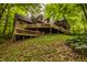 Exterior of a home with a deck and forest in the background at 7249 Tuliptree Trl, Indianapolis, IN 46256