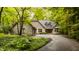 Charming brick home with mature trees, landscaping, and a circular driveway at 7249 Tuliptree Trl, Indianapolis, IN 46256