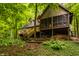The house is in a wooded area with multilevel decks and stairs; a serene blend of nature and home at 7249 Tuliptree Trl, Indianapolis, IN 46256