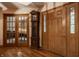 Inviting foyer featuring hardwood floors, a grandfather clock, and classic wood doors at 7249 Tuliptree Trl, Indianapolis, IN 46256