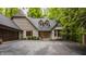 Traditional home featuring brick and wood, complemented by a spacious driveway and manicured shrubs at 7249 Tuliptree Trl, Indianapolis, IN 46256