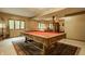 Finished game room with a window to the back yard, pool table, and carpet at 7249 Tuliptree Trl, Indianapolis, IN 46256