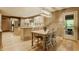 Eat-in kitchen featuring an island, stainless appliances, and adjacent breakfast nook at 7249 Tuliptree Trl, Indianapolis, IN 46256