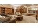 Spacious living room featuring a staircase, hardwood cabinet, and comfortable seating at 7249 Tuliptree Trl, Indianapolis, IN 46256