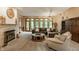 Cozy living room with a fireplace, large windows, and comfortable furniture at 7249 Tuliptree Trl, Indianapolis, IN 46256