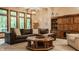 Comfortable living area featuring large windows, hardwood cabinet, and stylish furnishings at 7249 Tuliptree Trl, Indianapolis, IN 46256