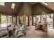 Screened in porch with wicker seating, a vaulted ceiling, and views of the trees at 7249 Tuliptree Trl, Indianapolis, IN 46256