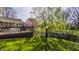 Expansive backyard featuring a deck, bird feeder, lush greenery, and mature trees at 757 Howe Dr, Carmel, IN 46032