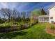 A spacious yard featuring a lush lawn, privacy fence, and mature trees provide a relaxing outdoor space at 757 Howe Dr, Carmel, IN 46032