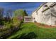 Spacious backyard with lush lawn, mature trees, and access to a screened-in porch at 757 Howe Dr, Carmel, IN 46032